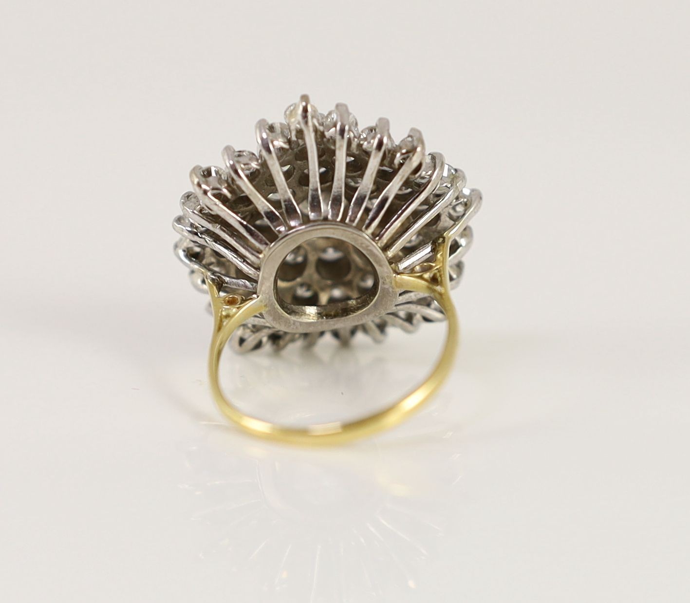 An impressive gold, platinum and diamond set circular cluster ring
